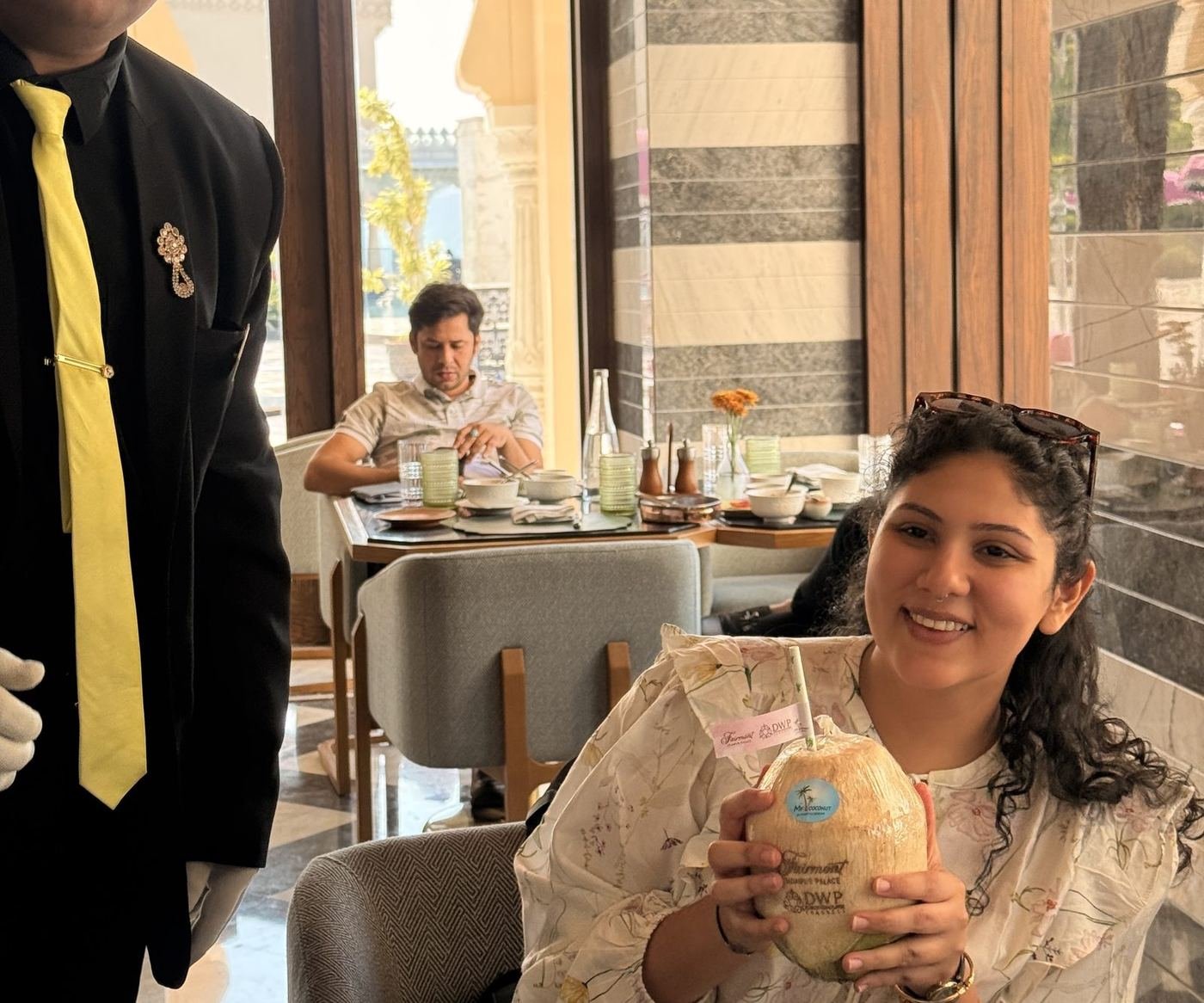 Guest smiling with a personalised engraved coconut at the table