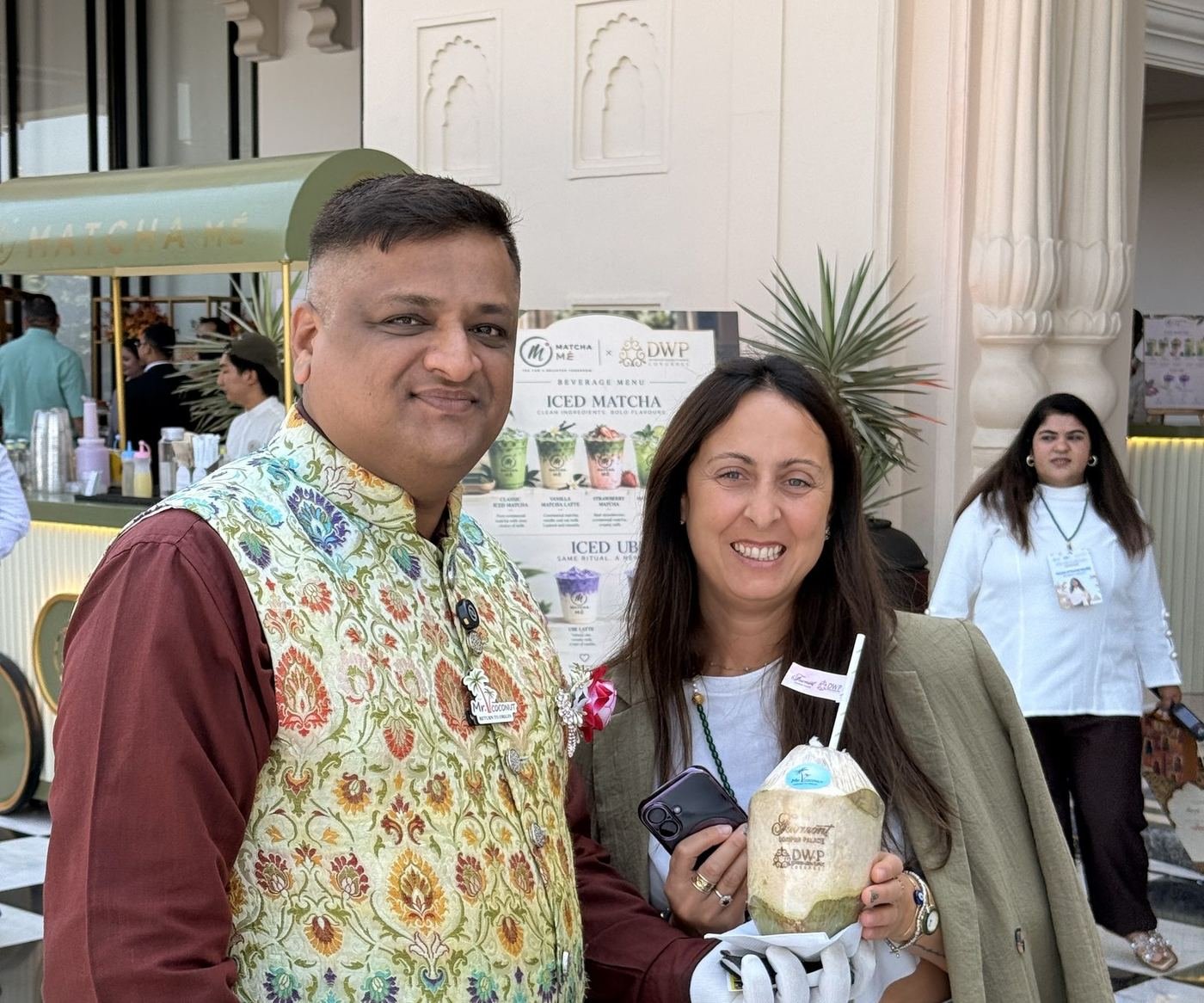 Guest holding a coconut with a straw and flag
