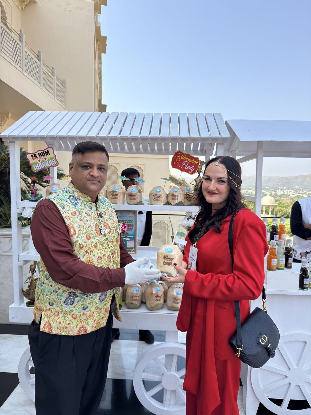 Guest in red receiving a coconut at the CocoCart