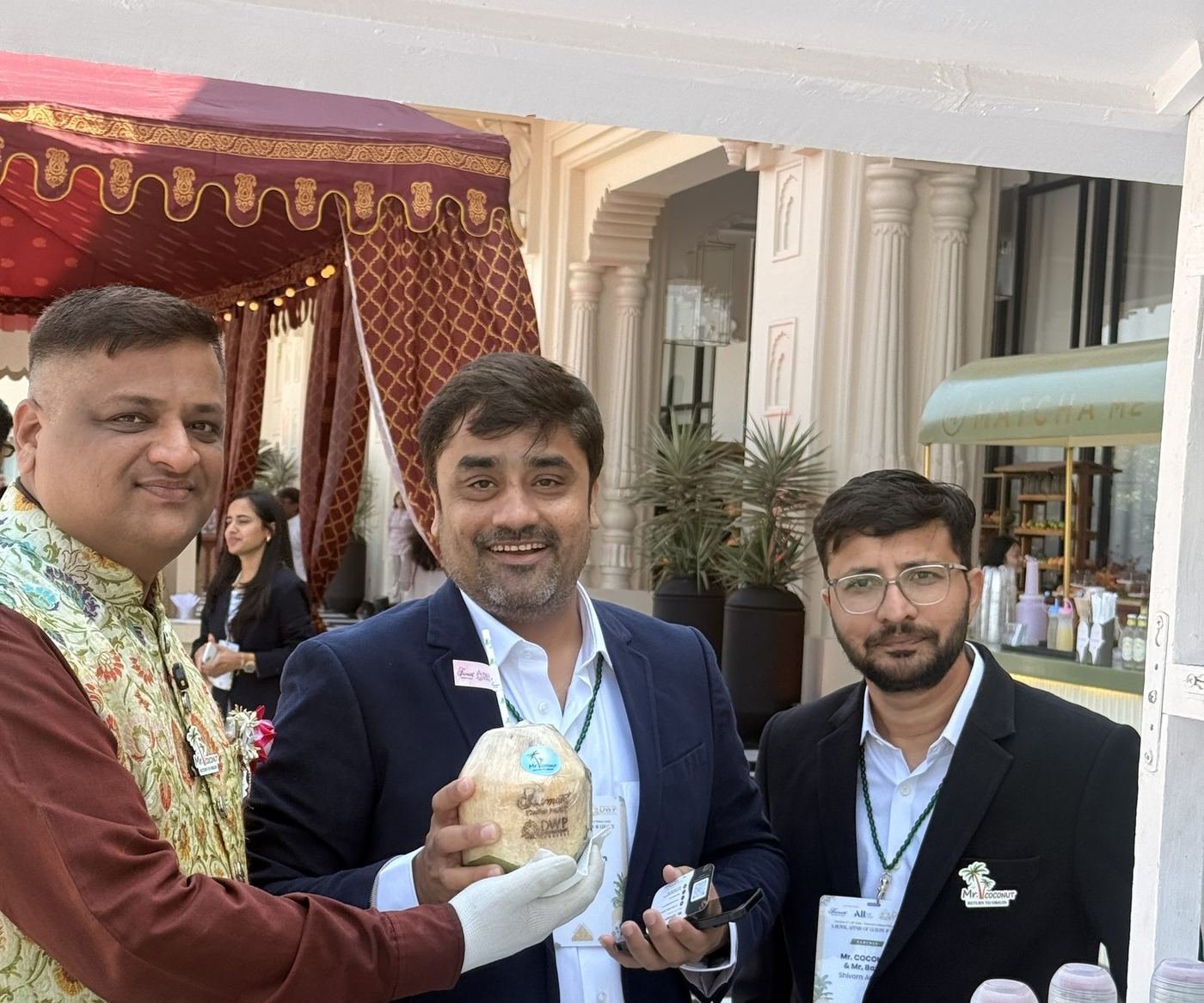 Group of guests holding personalised coconuts