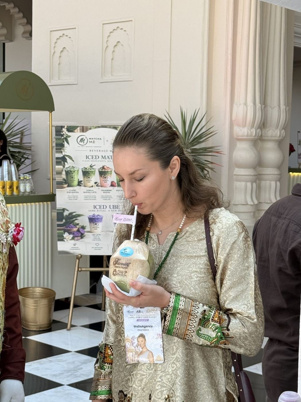 Guest sipping coconut water, a candid moment