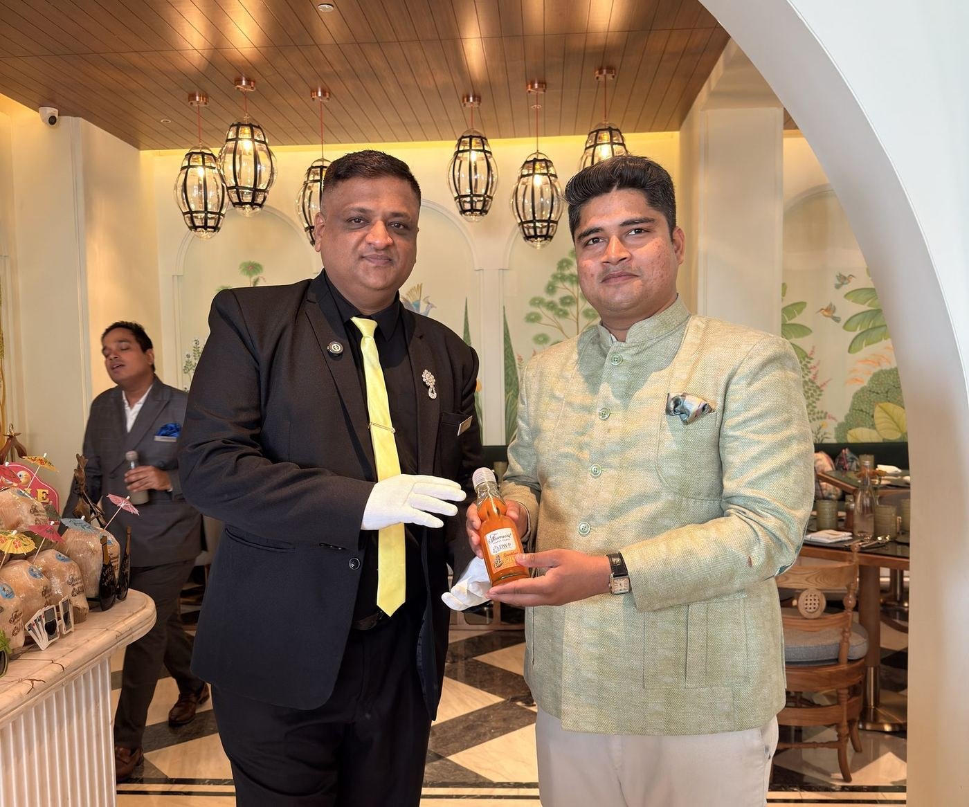 Mr. Coconut team handing over a coconut indoors