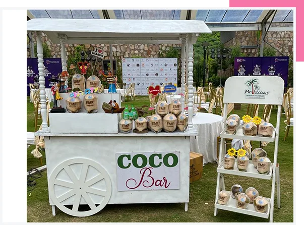 Wedding guests enjoying fresh coconuts engraved with custom names