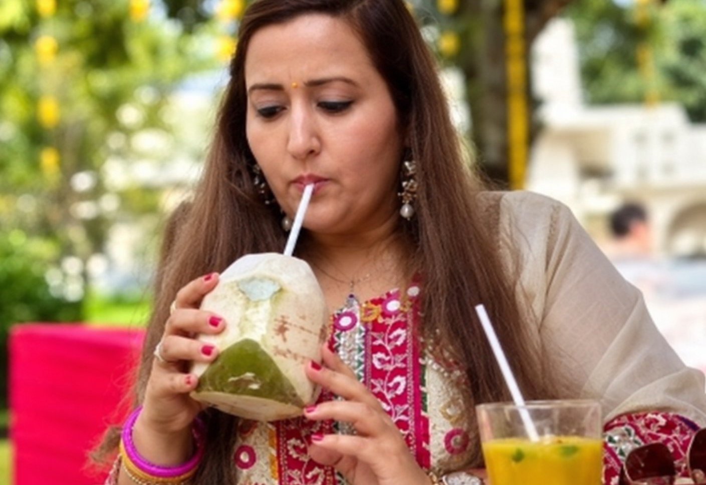 Event guests smiling with customized coconut drinks from coconut stall