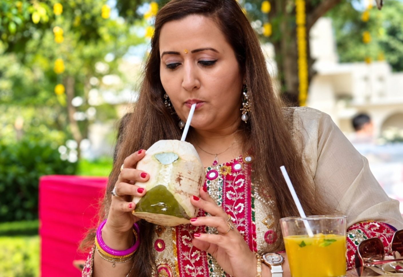 Event guests smiling with customized coconut drinks from coconut stall